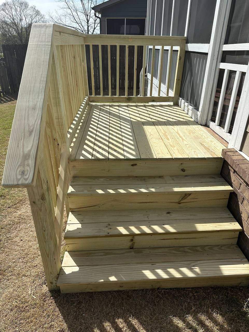 New pressure-treated back door landing platform and stairs with picket railing in Chattanooga
