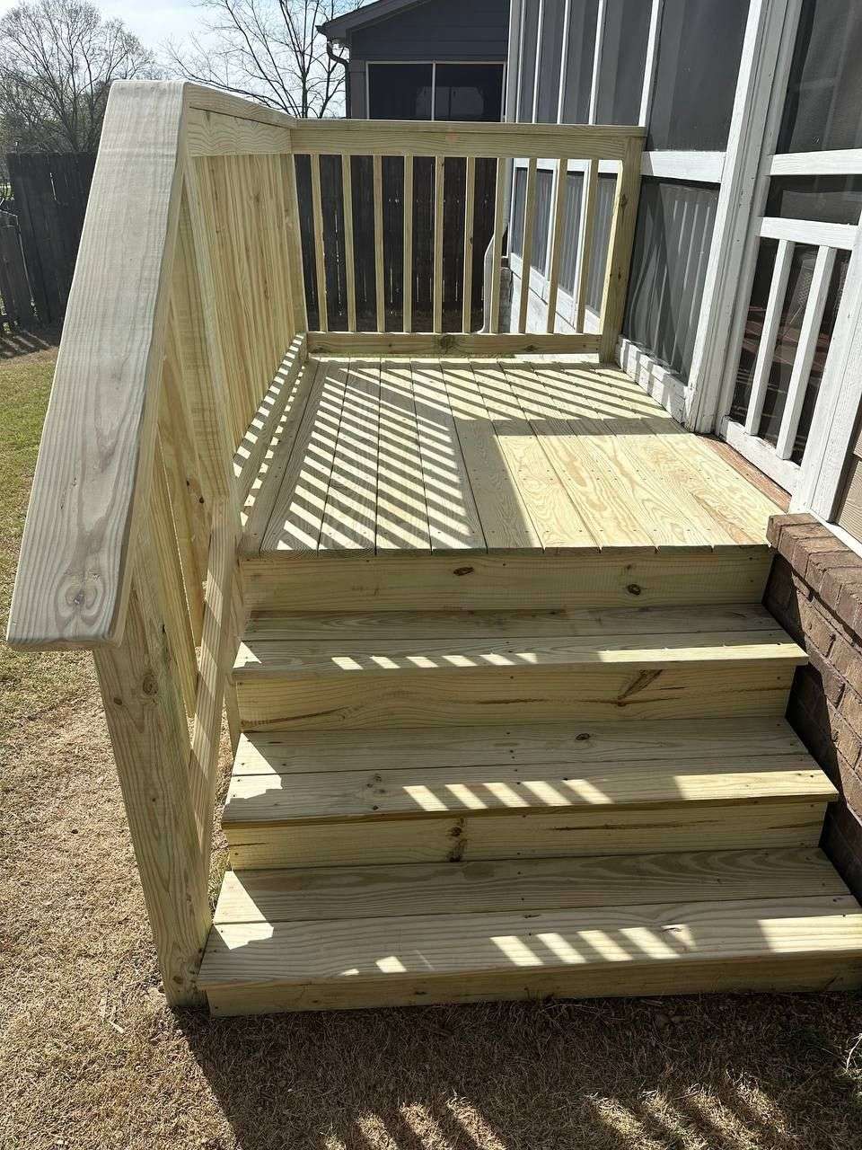 New pressure-treated back door landing platform and stairs with picket railing in Chattanooga