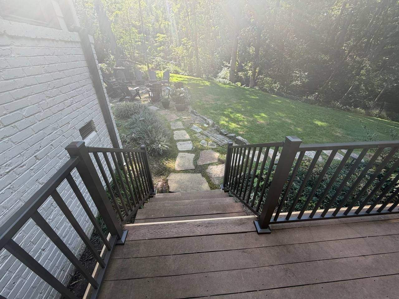 Large elevated deck with black aluminum railing and integrated stairs, new pressure-treated framing, Chattanooga TN