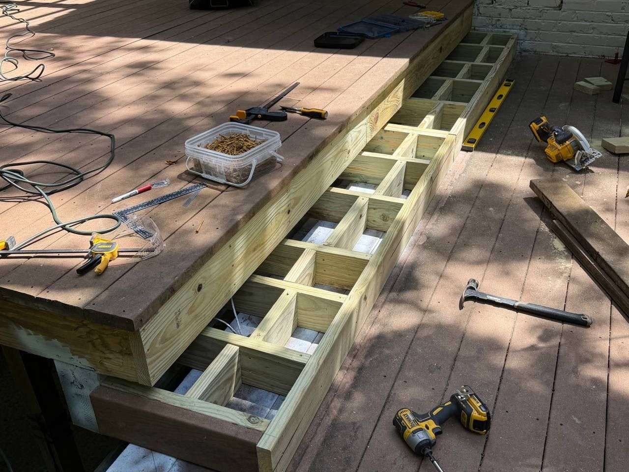 Newly rebuilt pressure-treated deck stairs with new stringers and framing, replacing rotted structural wood in Chattanooga