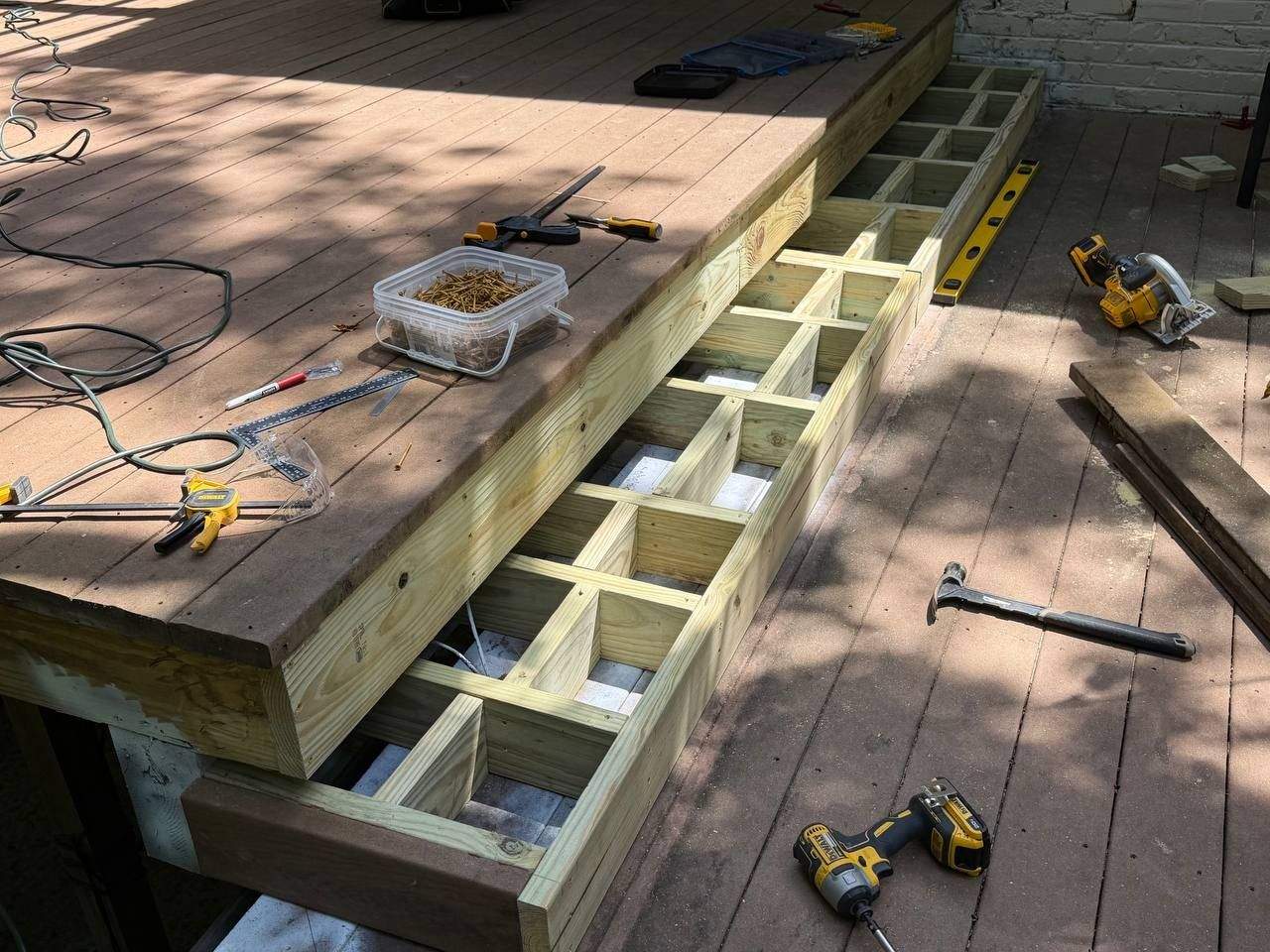 Newly rebuilt pressure-treated deck stairs with new stringers and framing, replacing rotted structural wood in Chattanooga