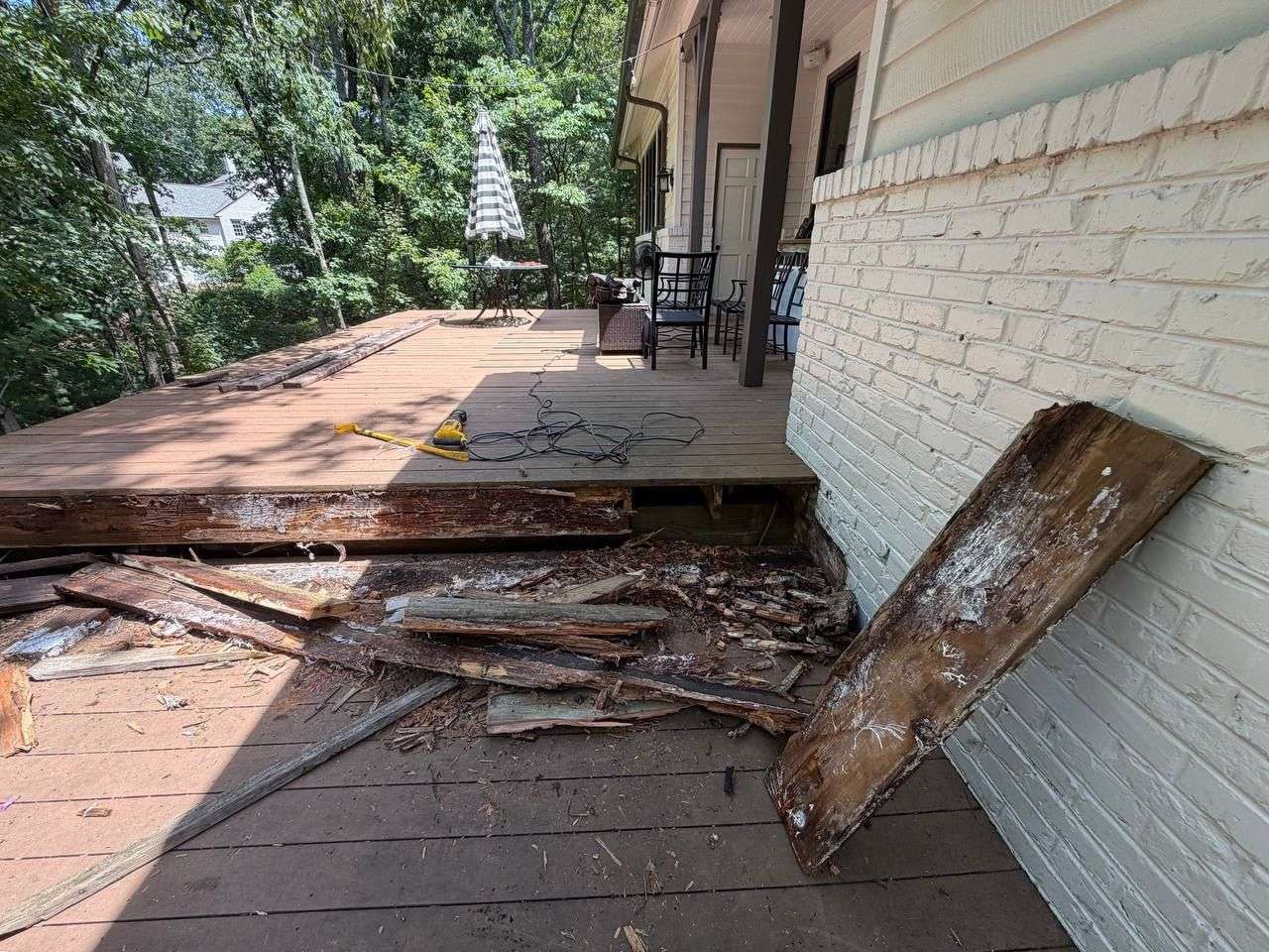 Rotted deck stair stringers and joist framing before structural rebuild in Chattanooga, TN